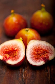 Fresh figs macro closeup over old wood boards
