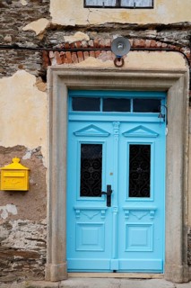 Renovated blue door and yellow letterbox