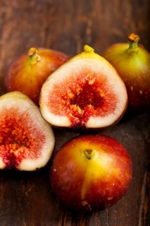 Fresh figs macro closeup over old wood boards