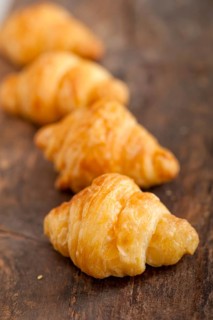 Fresh croissant french brioche over old wood table