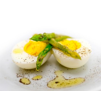 Boiled fresh green asparagus and eggs with extra virgin olive oil