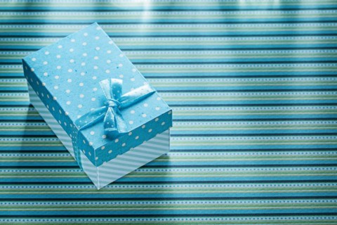 Blue present box on stripy table cloth celebrations concept