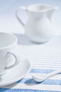 Composition of the white cup and spoon and jug