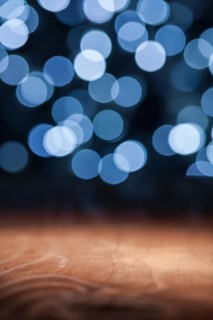 Blank wooden deck table with lights bokeh background ready for your product display mounting