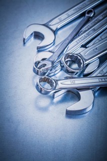 Flat spanner and open-end spanner on a metallic background Repair concept