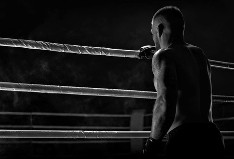 Kickboxer climbs into the ring. View from the back. Sports competitions. Fight night. The concept of mixed martial arts. MMA