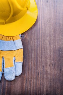 Glove and helmet on old wooden board with Copyspace concept