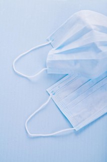 Disposable face masks on a blue background