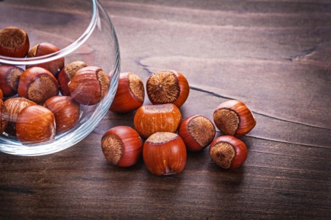 Food and drink concept Stack of hazelnuts in glass jar