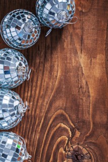 Christmas toy mirror disco balls on old wooden board with copy space