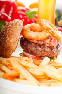 Classic american hamburger sandwich with onion rings and french fries