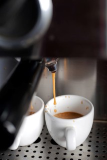 Italian espresso coffe making with professional machine macro