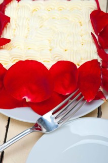 Whipped cream mango cake with red rose petals