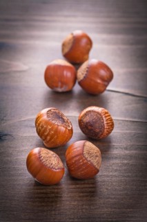 Seven hazelnuts on vintage wooden board Food and drink concept