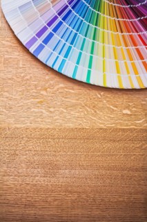 Multi-coloured Pantone fan on wooden board Construction concept