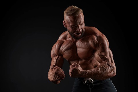 Handsome strong athletic men pumping up muscles. Workout