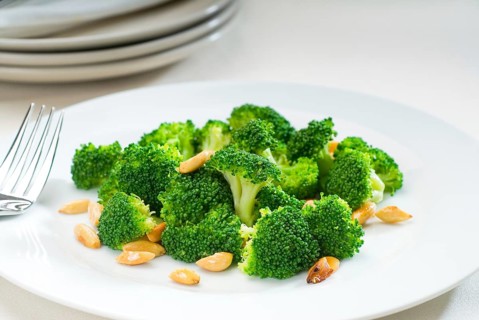 Fresh and vivid sauteed broccoli and almonds very ealthy food