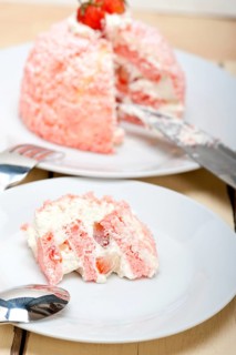 Fresh pink strawberry and whipped cream dessert macro close up
