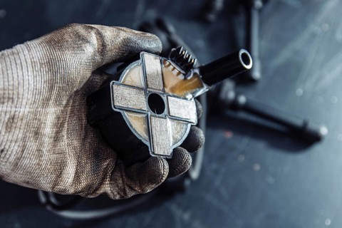 Engine ignition coil in hand of auto mechanic