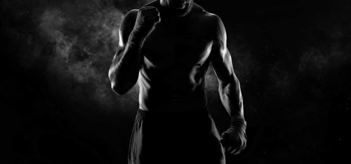 Noname image of a kickboxer on a dark background. The concept of mixed martial arts. MMA