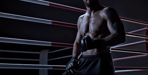 Kickboxer showing thumbs up standing near the ring. Sports competitions. Fight night. The concept of mixed martial arts. MMA