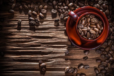 Coffee beans bowl on vintage wooden board