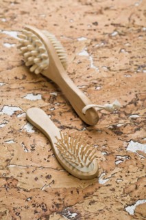 Massager and hairbrush on cork wood
