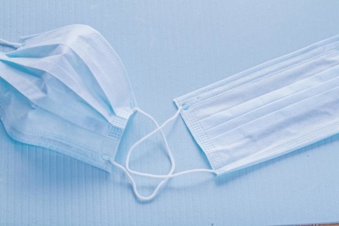 Medical concept Disposable face masks on a blue background