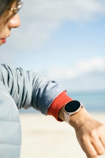 Close-up view of latina woman looking at smart watch