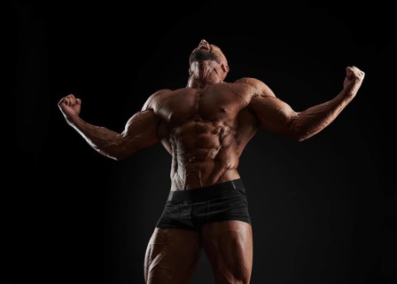 Handsome strong athletic men pumping up muscles. Workout