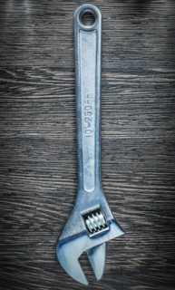 Adjustable spanner on wooden board