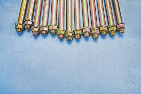 Assembly of anchor bolts for concrete walls with nuts on a metallic substrate Construction concept
