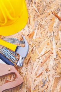 Copyspace image set of construction tools helmet claw hammer nails and handsaw on plywood