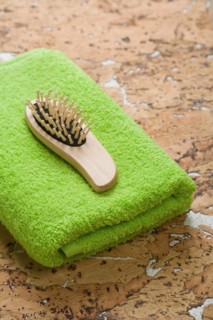 Hairbrush on green towel