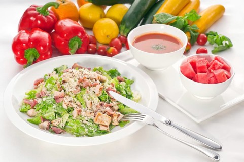 Fresh classic caesar salad served with gazpacho soup