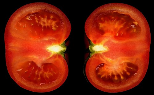 Ripe tomato cutted in half on black background
