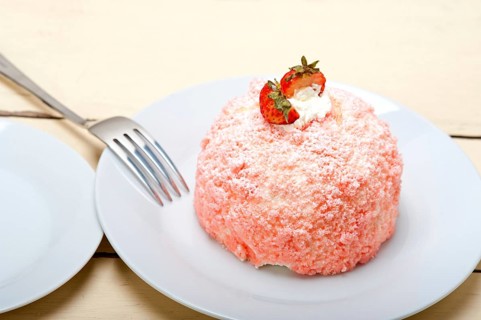 Fresh pink strawberry and whipped cream dessert macro close up