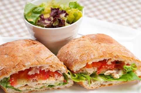 Italian ciabatta panini sandwich with chicken and tomato