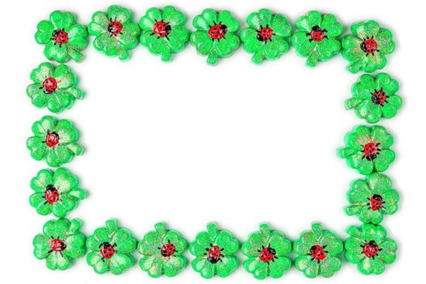 A frame of green shamrocks with ladybirds