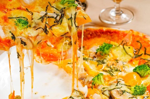 Fresh italian thin style vegetarian pizza with fresh mixed vegetables close up