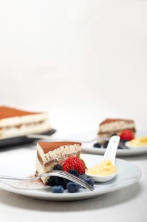 Classic Italian tiramisu dessert with berries and custartd pastry cream on side