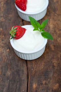 Organic Greek yogurt and strawberry on a rustic wood table
