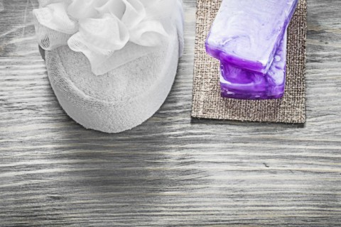 Bars of handmade soap white bath sponge on wooden board spa treatment concept