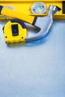 Construction level band line claw hammer on metallic background maintenance concept