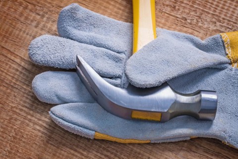 Claw hammer on glove close-up