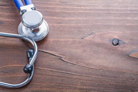 Copyspace close-up medical stethoscope on vintage wooden board medical concept