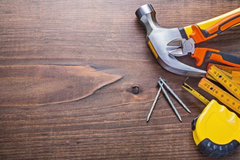 Copyspace image claw hammer nails tapeline wooden metre pliers on vintage board building concept