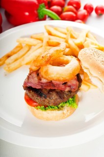 Classic american hamburger sandwich with onion rings and french fries