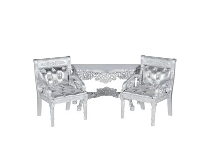 Two silver leather upholstery chairs with silver table on middle