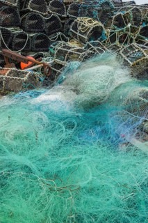 Turquoise fishing net and lobster baskets